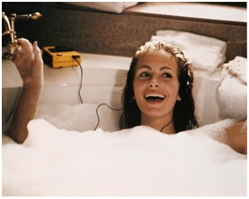 Woman in a bathtub listening to a Walkman.